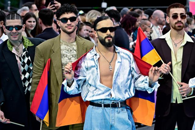 Armenian singer Simon Hovhannisyan, aka Simon and representing Armenia with the song 'Paloma Rumba', pose for photographers on the turquoise carpet for the opening ceremony of the Eurovision Song Contest 2026 at the City Hall Square in Vienna, Austria on May 10, 2026. The event is the official starting point of Eurovision week in Vienna. The city will host the two semi-finals on May 12 and May 14 and the final on May 16, 2026. (Photo by Tobias SCHWARZ / AFP)