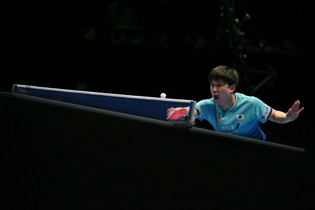 Japan's Tomokazu Harimoto returns against China's Liang Jingkun during their Men's Teams final match at the ITTF World Table Tennis Championships in Wembley Arena, west London on May 10, 2026. (Photo by Glyn KIRK / AFP)
