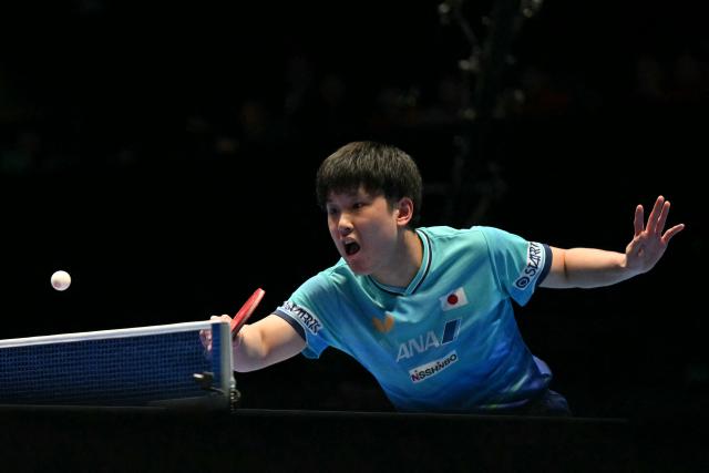 Japan's Tomokazu Harimoto returns against China's Liang Jingkun during their Men's Teams final match at the ITTF World Table Tennis Championships in Wembley Arena, west London on May 10, 2026. (Photo by Glyn KIRK / AFP)
