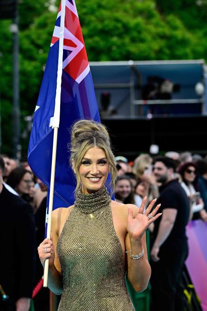 Australian singer Delta Goodrem, representing Australia with the song 'Eclipse', pose for photos on the turquoise carpet for the opening ceremony of the Eurovision Song Contest 2026 at the City Hall Square in Vienna, Austria on May 10, 2026. The event is the official starting point of Eurovision week in Vienna. The city will host the two semi-finals on May 12 and May 14 and the final on May 16, 2026. (Photo by Tobias SCHWARZ / AFP)