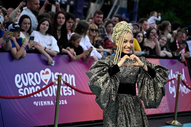 Monroe Vata Rigby, aka Monroe and representing France with the song 'Regarde !', pose for photographers on the turquoise carpet for the opening ceremony of the Eurovision Song Contest 2026 at the City Hall Square in Vienna, Austria on May 10, 2026. The event is the official starting point of Eurovision week in Vienna. The city will host the two semi-finals on May 12 and May 14 and the final on May 16, 2026. (Photo by Tobias SCHWARZ / AFP)