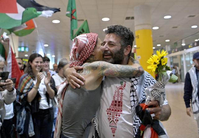 Spanish activist from a Gaza-bound aid flotilla Saif Abu Keshek is hugged as he arrived after being released by Israeli authorities at Barcelona airport, on May 10, 2026. Israeli forces intercepted the flotilla in international waters off Greece last week, expelling the activists to Europe but arresting Abu Keshek and another activist from Gaza-bound aid flotilla. (Photo by MANAURE QUINTERO / AFP)