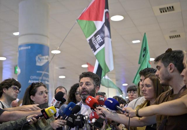 Spanish activist from a Gaza-bound aid flotilla Saif Abu Keshek (C) talks to media as he arrived after being released by Israeli authorities at Barcelona airport, on May 10, 2026. Israeli forces intercepted the flotilla in international waters off Greece last week, expelling the activists to Europe but arresting Abu Keshek and another activist from Gaza-bound aid flotilla. (Photo by MANAURE QUINTERO / AFP)