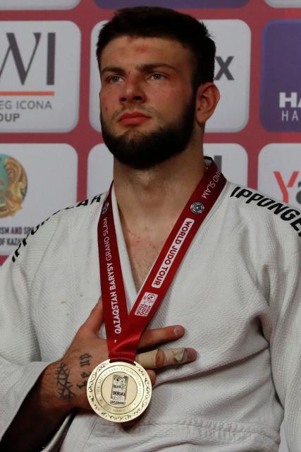 Gold medallist Serbia's Boris Rutovic celebrates on the podium for the men's under 90 kg event at the Astana Grand Slam judo tournament in Astana on May 10, 2026. (Photo by STANISLAV FILIPPOV / AFP)
