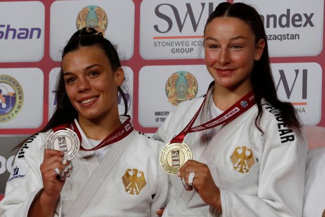 Silver medallist Germany's Alina Boehm and gold medallist Germany's Anna Monta Olek celebrate on the podium for the women's under 78 kg event at the Astana Grand Slam judo tournament in Astana on May 10, 2026. (Photo by STANISLAV FILIPPOV / AFP)