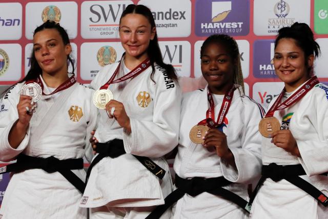 Silver medallist Germany's Alina Boehm, gold medallist Germany's Anna Monta Olek and bronze medallists France's Liz Ngelebeya and Brazil's Beatriz Freitas celebrate on the podium for the women's under 78 kg event at the Astana Grand Slam judo tournament in Astana on May 10, 2026. (Photo by STANISLAV FILIPPOV / AFP)