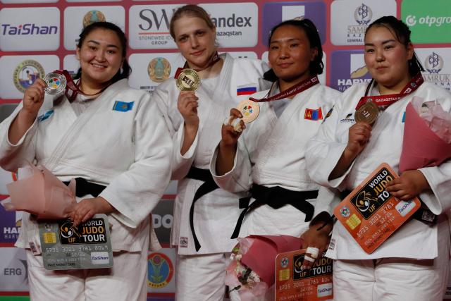 Silver medallist Kazakhstan's Kamila Berlikash, gold medallist Russia's Elis Startseva and bronze medallists Mongolia's Adiyasuren Amarsaikhan and Kazakhstan's Aida Toishibekova celebrate on the podium for the women's over 78 kg event at the Astana Grand Slam judo tournament in Astana on May 10, 2026. (Photo by STANISLAV FILIPPOV / AFP)