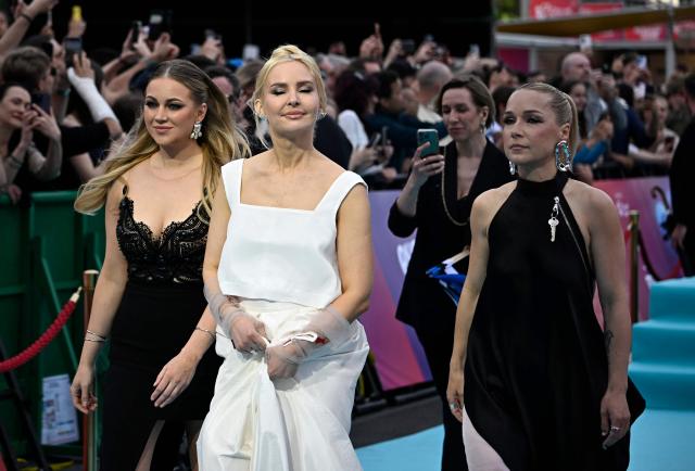 Estonian singers Lenna Kuurmaa, Piret Jarvis-Milder and Kerli Kivilaan of band Vanilla Ninja and representing Estonia with the song 'Too Epic To Be True', pose for photographers on the turquoise carpet for the opening ceremony of the Eurovision Song Contest 2026 at the City Hall Square in Vienna, Austria on May 10, 2026. The event is the official starting point of Eurovision week in Vienna. The city will host the two semi-finals on May 12 and May 14 and the final on May 16, 2026. (Photo by Tobias SCHWARZ / AFP)