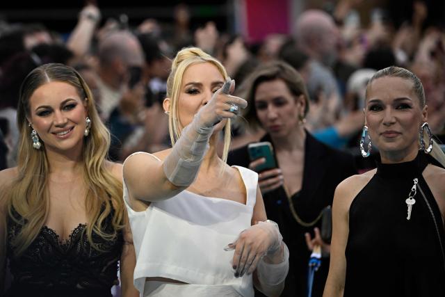 Estonian singers Lenna Kuurmaa, Piret Jarvis-Milder and Kerli Kivilaan of band Vanilla Ninja and representing Estonia with the song 'Too Epic To Be True', pose for photographers on the turquoise carpet for the opening ceremony of the Eurovision Song Contest 2026 at the City Hall Square in Vienna, Austria on May 10, 2026. The event is the official starting point of Eurovision week in Vienna. The city will host the two semi-finals on May 12 and May 14 and the final on May 16, 2026. (Photo by Tobias SCHWARZ / AFP)