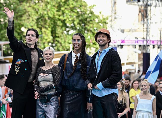 Danish singer Soeren Torpegaard Lund (L), representing Denmark with the song 'For Vi Gar Hjem', poses for photographers on the turquoise carpet for the opening ceremony of the Eurovision Song Contest 2026 at the City Hall Square in Vienna, Austria on May 10, 2026. The event is the official starting point of Eurovision week in Vienna. The city will host the two semi-finals on May 12 and May 14 and the final on May 16, 2026. (Photo by Tobias SCHWARZ / AFP)