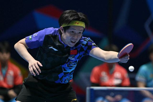 China's Wang Chuqin returns against Japan's Sora Matsushima during their Men's Teams final match at the ITTF World Table Tennis Championships in Wembley Arena, west London on May 10, 2026. (Photo by Glyn KIRK / AFP)