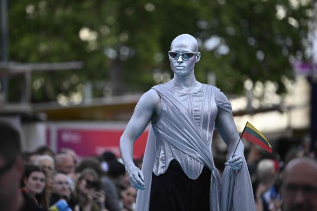 Lithuanian singer Lion Ceccah, representing Lithuania with the song 'Solo Quiero Mas', pose for photographers on the turquoise carpet for the opening ceremony of the Eurovision Song Contest 2026 at the City Hall Square in Vienna, Austria on May 10, 2026. The event is the official starting point of Eurovision week in Vienna. The city will host the two semi-finals on May 12 and May 14 and the final on May 16, 2026. (Photo by Tobias SCHWARZ / AFP)