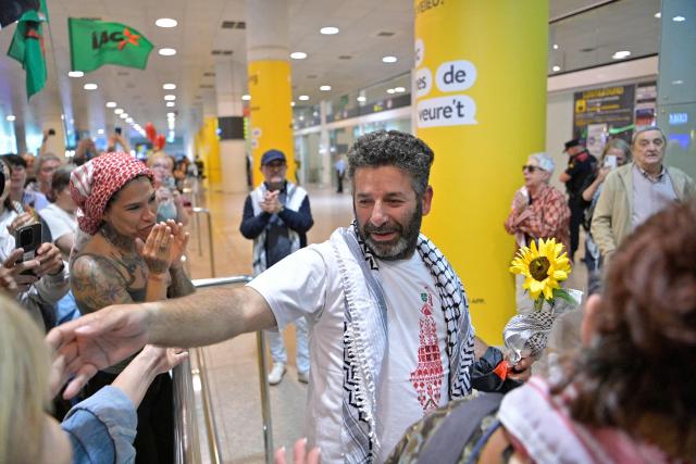 Spanish activist from a Gaza-bound aid flotilla Saif Abu Keshek is welcomed as he arrived after being released by Israeli authorities at Barcelona airport, on May 10, 2026. Israeli forces intercepted the flotilla in international waters off Greece last week, expelling the activists to Europe but arresting Abu Keshek and another activist from Gaza-bound aid flotilla. (Photo by MANAURE QUINTERO / AFP)