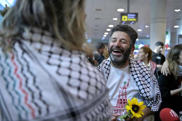 Spanish activist from a Gaza-bound aid flotilla Saif Abu Keshek is welcomed as he arrived after being released by Israeli authorities at Barcelona airport, on May 10, 2026. Israeli forces intercepted the flotilla in international waters off Greece last week, expelling the activists to Europe but arresting Abu Keshek and another activist from Gaza-bound aid flotilla. (Photo by MANAURE QUINTERO / AFP)