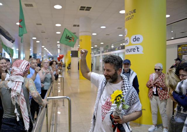 Spanish activist from a Gaza-bound aid flotilla Saif Abu Keshek is welcomed as he arrives after being released by Israeli authorities at Barcelona airport, on May 10, 2026. Israeli forces intercepted the flotilla in international waters off Greece last week, expelling the activists to Europe but arresting Abu Keshek and another activist from Gaza-bound aid flotilla. (Photo by MANAURE QUINTERO / AFP)