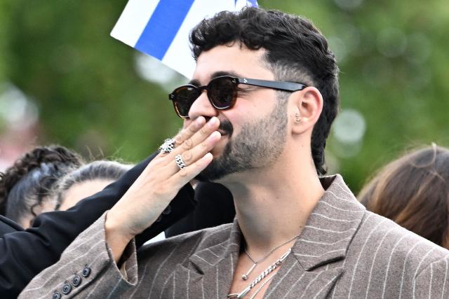 Israeli singer Noam Bettan, representing Israel with the song 'Michelle', poses for photographers on the turquoise carpet for the opening ceremony of the Eurovision Song Contest 2026 at the City Hall Square in Vienna, Austria on May 10, 2026. The event is the official starting point of Eurovision week in Vienna. The city will host the two semi-finals on May 12 and May 14 and the final on May 16, 2026. (Photo by Tobias SCHWARZ / AFP)