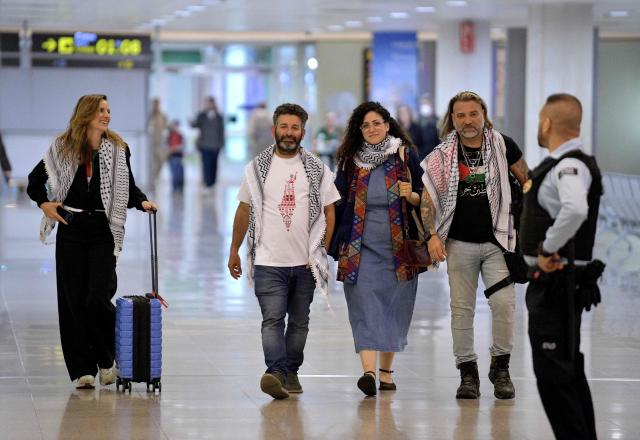 Spanish national of Palestinian origin Saif Abu Keshek (C), activist from a Gaza-bound aid flotilla, leaves Barcelona airport, on May 10, 2026  upon his arrival following his release by Israeli authorities. Israeli forces intercepted the flotilla in international waters off Greece last week, expelling the activists to Europe but arresting Abu Keshek and another activist from Gaza-bound aid flotilla. (Photo by MANAURE QUINTERO / AFP)