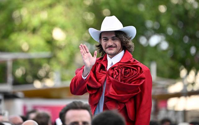 Maltese singer Aidan Cassar, aka Aidan and representing Malta with the song 'Bella', pose for photographers on the turquoise carpet for the opening ceremony of the Eurovision Song Contest 2026 at the City Hall Square in Vienna, Austria on May 10, 2026. The event is the official starting point of Eurovision week in Vienna. The city will host the two semi-finals on May 12 and May 14 and the final on May 16, 2026. (Photo by Tobias SCHWARZ / AFP)