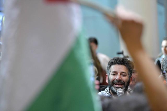 Spanish activist from a Gaza-bound aid flotilla Saif Abu Keshek talks to media and supporters as he arrives after being released by Israeli authorities at Barcelona airport, on May 10, 2026. Israeli forces intercepted the flotilla in international waters off Greece last week, expelling the activists to Europe but arresting Abu Keshek and another activist from Gaza-bound aid flotilla. (Photo by MANAURE QUINTERO / AFP)