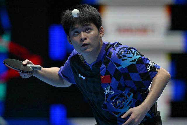 China's Lin Shidong serves against Japan's Shunsuke Togami during their Men's Teams final match at the ITTF World Table Tennis Championships in Wembley Arena, west London on May 10, 2026. (Photo by Glyn KIRK / AFP)