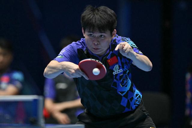 China's Lin Shidong returns against Japan's Shunsuke Togami during their Men's Teams final match at the ITTF World Table Tennis Championships in Wembley Arena, west London on May 10, 2026. (Photo by Glyn KIRK / AFP)