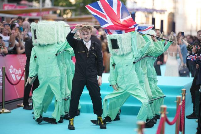 English musician Sam Battle, aka Look Mum No Computer and representing Great Britain with the song 'Eins, Zwei, Drei', pose for photographers on the turquoise carpet for the opening ceremony of the Eurovision Song Contest 2026 at the City Hall Square in Vienna, Austria on May 10, 2026. The event is the official starting point of Eurovision week in Vienna. The city will host the two semi-finals on May 12 and May 14 and the final on May 16, 2026. (Photo by GEORG HOCHMUTH / APA / AFP) / Austria OUT
