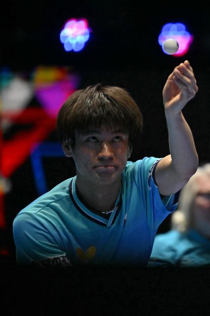 Japan's Shunsuke Togami serves against China's Lin Shidong during their Men's Teams final match at the ITTF World Table Tennis Championships in Wembley Arena, west London on May 10, 2026. (Photo by Glyn KIRK / AFP)