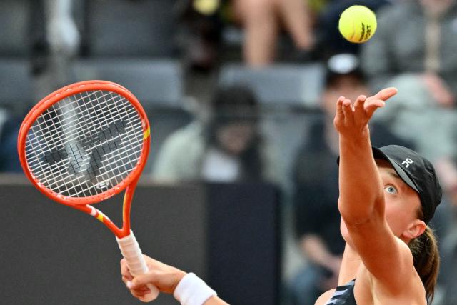 Poland's Iga Swiatek serves to Italy's Elisabetta Cocciaretto during their women's singles match at the WTA Rome Open tennis tournament at Foro Italico in Rome on May 10, 2026. (Photo by Alberto PIZZOLI / AFP)