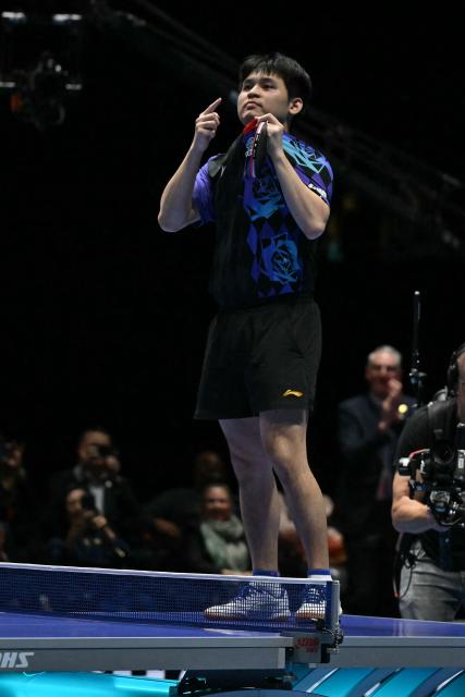 China's Lin Shidong reacts after beating Japan's Shunsuke Togami to secure China's victory in the Men's Teams final match at the ITTF World Table Tennis Championships in Wembley Arena, west London on May 10, 2026. China beat Japan 3-0. (Photo by Glyn KIRK / AFP)