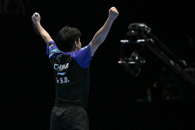 China's Lin Shidong reacts after beating Japan's Shunsuke Togami to secure China's victory in the Men's Teams final match at the ITTF World Table Tennis Championships in Wembley Arena, west London on May 10, 2026. China beat Japan 3-0. (Photo by Glyn KIRK / AFP)
