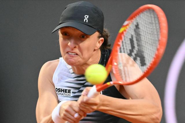 Poland's Iga Swiatek plays a backhand return to Italy's Elisabetta Cocciaretto during their women's singles match at the WTA Rome Open tennis tournament at Foro Italico in Rome on May 10, 2026. (Photo by Alberto PIZZOLI / AFP)