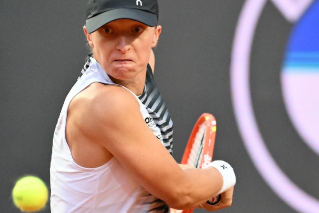 Poland's Iga Swiatek plays a backhand return to Italy's Elisabetta Cocciaretto during their women's singles match at the WTA Rome Open tennis tournament at Foro Italico in Rome on May 10, 2026. (Photo by Alberto PIZZOLI / AFP)