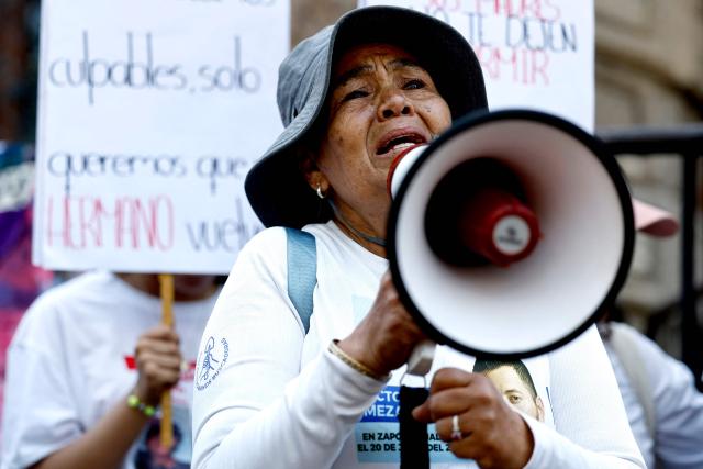A woman searching for her missing son speaks through a megaphone during a protest on Mother's Day, in Guadalajara, Jalisco state, Mexico, on May 10, 2026. (Photo by ULISES RUIZ / AFP)