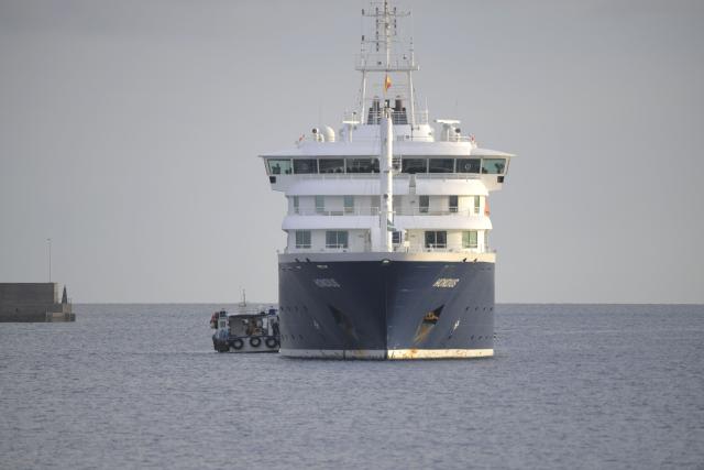 US passengers from the Dutch flagged hantavirus-stricken cruise ship MV Hondius are transferred by boat to the industrial port of Granadilla de Abona on the island of Tenerife in Spain's Canary Islands on May 10, 2026. Repatriation flights for the nearly 150 passengers onboard the ship hit by a deadly hantavirus outbreak got underway as passengers and some crew members were transferred to shore on smaller vessels then by bus to the airport and then flown home after weeks at sea. (Photo by JORGE GUERRERO / AFP)