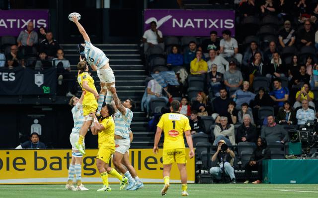 Racing92's French flanker Maxime Baudonne (C) jumps to catch the ball in a line out during the French Top14 rugby union match between Racing 92 and Stade Rochelais (La Rochelle) at the Paris La Defense Arena in Nanterre, on the outskirts of Paris on May 10, 2026. (Photo by GEOFFROY VAN DER HASSELT / AFP)