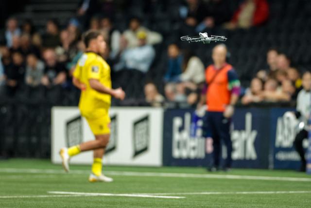 A drone flies over the playing area during the French Top14 rugby union match between Racing 92 and Stade Rochelais (La Rochelle) at the Paris La Defense Arena in Nanterre, on the outskirts of Paris on May 10, 2026. (Photo by GEOFFROY VAN DER HASSELT / AFP)