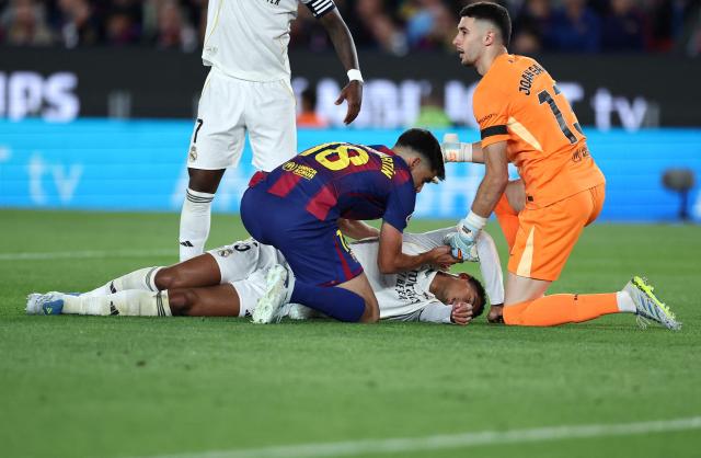 Real Madrid's English midfielder #05 Jude Bellingham injured lies on the ground during the Spanish league football match between FC Barcelona and Real Madrid CF at Camp Nou Stadium in Barcelona on May 10, 2026. (Photo by Josep LAGO / AFP)