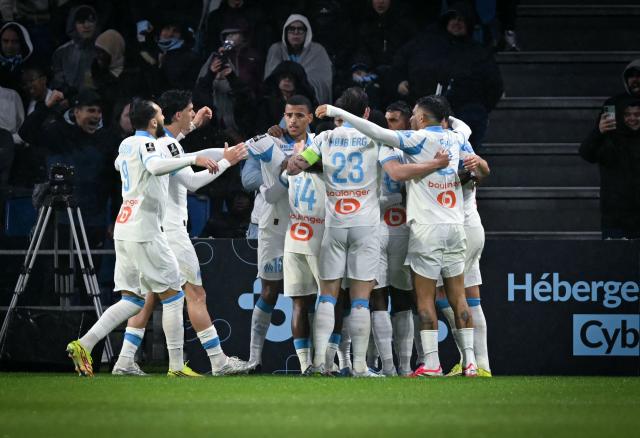 Marseille's English forward #10 Mason Greenwood (C) celebrates with teammates after scoring a penalty his teams' first goal during the French L1 football match between Le Havre AC and Olympique de Marseille (OM) at the Stade Oceane in Le Havre, north-western France on May 10, 2026. (Photo by LOU BENOIST / AFP)