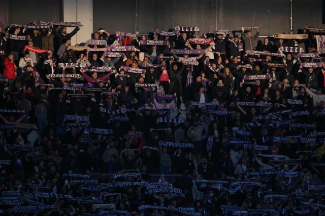 Toulouse supporters wave their scarves during the French L1 football match between Toulouse FC and Olympique Lyonnais (OL) at the TFC Stadium in Toulouse, southwestern France, on May 10, 2026. (Photo by Ed JONES / AFP)