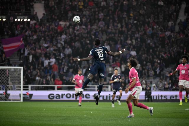 Lyon's Senegalese defender #19 Moussa Niakhate (C) heads the ball during the French L1 football match between Toulouse FC and Olympique Lyonnais (OL) at the TFC Stadium in Toulouse, southwestern France, on May 10, 2026. (Photo by Ed JONES / AFP)