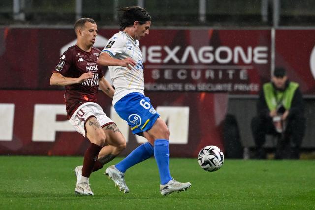 Lorient's French midfielder #06 Laurent Abergel (R) fights for the ball with Metz's French midfielder #10 Gauthier Hein during the French L1 football match between FC Metz and FC Lorient at the Stade Saint-Symphorien in Longeville-les-Metz, eastern France, on May 10, 2026. (Photo by Jean-Christophe VERHAEGEN / AFP)