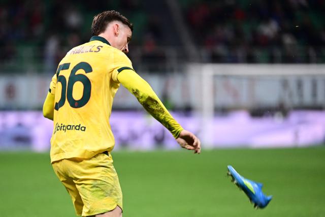 AC Milan's Belgian midfielder #56 Alexis Saelemaekers throws AC Milan's Swiss defender #24 Zachary Athekame’s shoe during the Italian Serie A football match between AC Milan and Atalanta Bergamo at San Siro Stadium in Milan on May 10, 2026. (Photo by Piero CRUCIATTI / AFP)