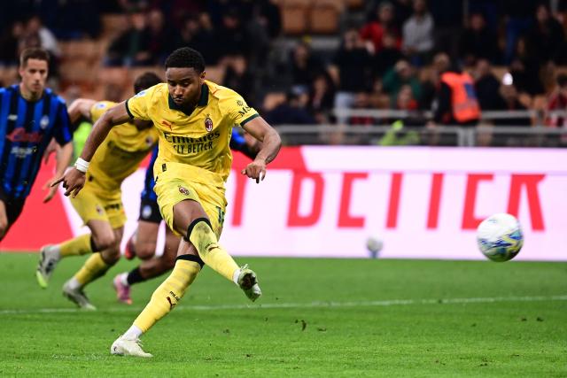 AC Milan's French forward #18 Christopher Nkunku scores a penalty kick during the Italian Serie A football match between AC Milan and Atalanta Bergamo at San Siro Stadium in Milan on May 10, 2026. (Photo by Piero CRUCIATTI / AFP)