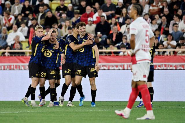 Lille's Belgian defender #12 Thomas Meunier (2nd L) celebrates with teammates after scoring a goal during the French L1 football match between Monaco (ASM) and Lille (LOSC) at the Louis II Stadium (Stade Louis II) in the Principality of Monaco on May 10, 2026. (Photo by Frederic DIDES / AFP)