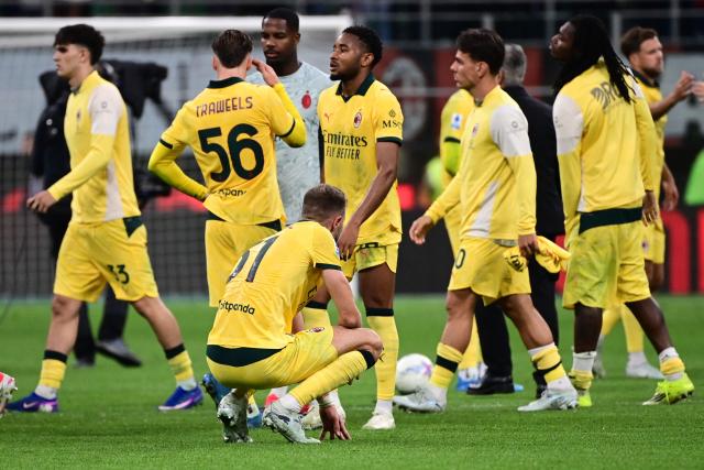 AC Milan's French forward #18 Christopher Nkunku (C) and teammates react at the end of the Italian Serie A football match between AC Milan and Atalanta Bergamo at San Siro Stadium in Milan on May 10, 2026. (Photo by Piero CRUCIATTI / AFP)