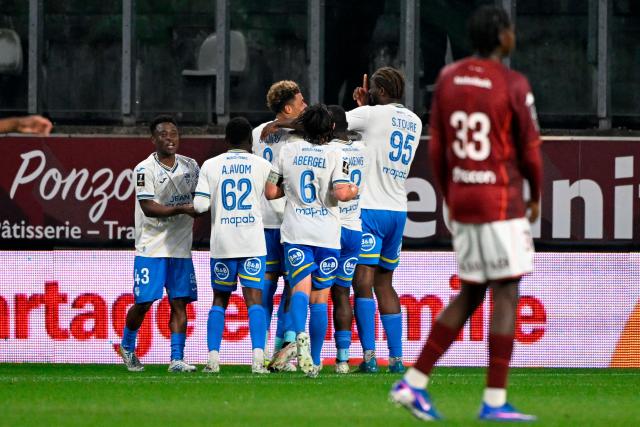 Lorient's players celebrate during the French L1 football match between FC Metz and FC Lorient at the Stade Saint-Symphorien in Longeville-les-Metz, eastern France on May 10, 2026. (Photo by Jean-Christophe VERHAEGEN / AFP)
