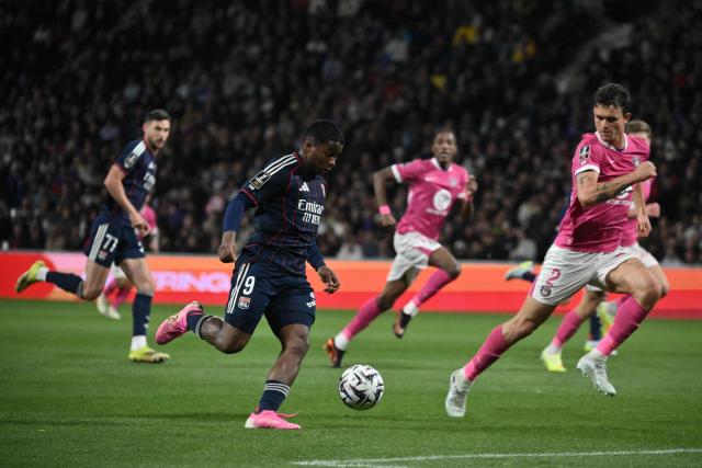 Toulouse's Danish defender #02 Rasmus Nicolaisen (R) looks on as Lyon's Brazilian forward #09 Endrick (C) runs with the ball during the French L1 football match between Toulouse FC and Olympique Lyonnais (OL) at the TFC Stadium in Toulouse, southwestern France, on May 10, 2026. (Photo by Ed JONES / AFP)