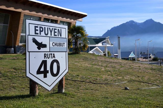 A sign reading "Epuyen, Chubut, Route 40" is seen at the entrance of the village of Epuyen, in Chubut province, Argentina, on May 9, 2026, where a hantavirus outbreak that killed 11 people took place in 2018-2019. (Photo by JUAN MABROMATA / AFP)