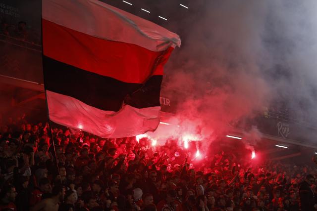 Rennes supporters wave a flag and light flares during the French L1 football match between Stade Rennais FC and Paris FC at the Roazhon Park stadium in Rennes, western France on May 10, 2026. (Photo by SIMON WOHLFAHRT / AFP)
