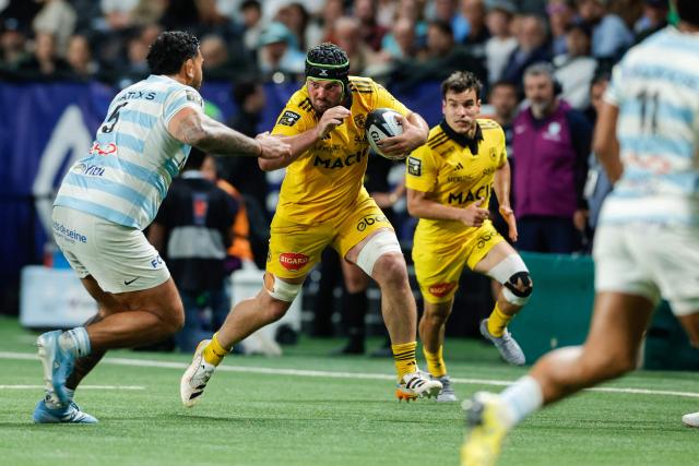 La Rochelle's French wing Gregory Alldritt (C) is tackled by Racing 92' French lock Romain Taofifenua as he runs with the ball during the French Top14 rugby union match between Racing 92 and Stade Rochelais (La Rochelle) at the Paris La Defense Arena in Nanterre, on the outskirts of Paris on May 10, 2026. (Photo by GEOFFROY VAN DER HASSELT / AFP)